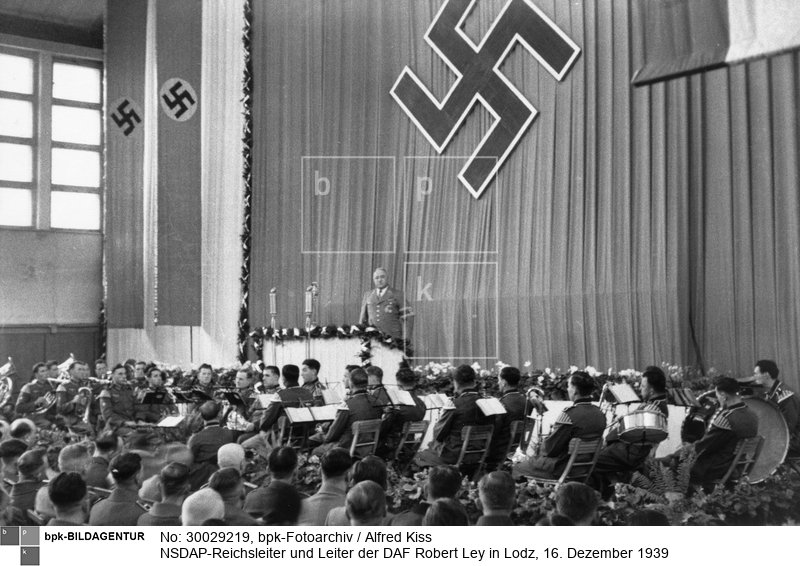 Ley bei seiner Rede in der Sporthalle<BR>Aufnahmedatum: 16.12.1939<BR>Material/Technik: Foto<BR>Aufnahmeort: Lodz (Lodsch, 1940-45 Litzmannstadt), Reichsgau Posen (1939-40), Reichsgau Wartheland (1940-45), Deutsches Reich (durch Annexion) / Łódź, Polen<BR>Inventar-Nr.: Ki I/056/17<BR>